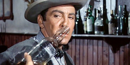 Cameron Mitchell as Bill, a shopkeeper being taunted with a whiskey bottle in The Last Gun (1964)