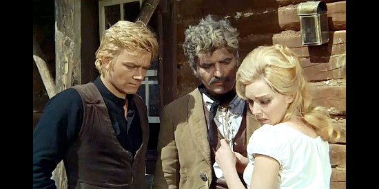 Dyanik Zurakowska as Dolly gets distressing news from Bill (Peter Lee Lawrence) and El Chato (Guglielmo Spoletini) in One by One Without Pity (1968)