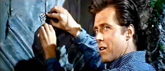 Ed Brynes as Clayton tries to figure out the location of the gold in Any Gun Can Play (1967)