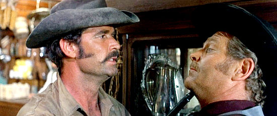 James Garner as Luther Sledge puts Sheriff Ripley (Wayde Preston) under the gun in A Man Called Sledge (1970)