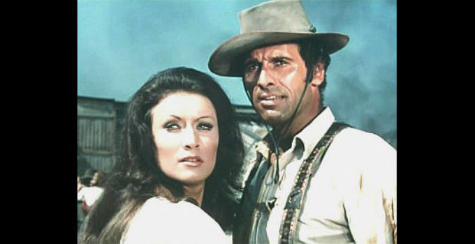 Malisa Longo as Jenny McKinley and Michael Forest as Sacramento, pulled together by an interest in loot from a train holdup in And Now They Call Him Sacramento (1972)