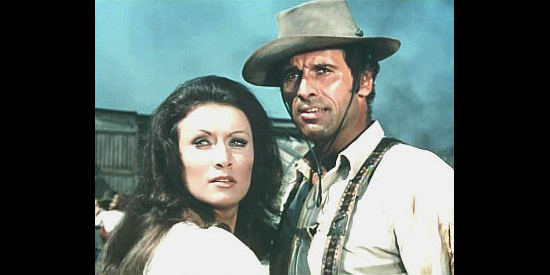Malisa Longo as Jenny McKinley and Michael Forest as Sacramento, pulled together by an interest in loot from a train holdup in And Now They Call Him Sacramento (1972)