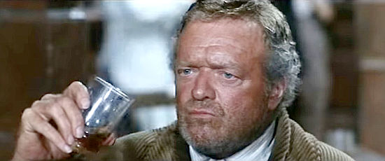 Van Heflin as Sam Cooper, ponders a question of truthworthyness in The Ruthless Four (1967)