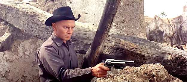 Yul Brynner as Chris, taking aim at one of Lorca's bandits in Return of the Seven (1966)