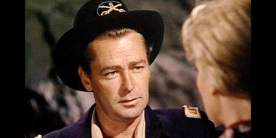 Alan Ladd as Capt. Brett Sherwood, donning the disguise of the Union blue for a Rebel mission in Red Mountain (1951)