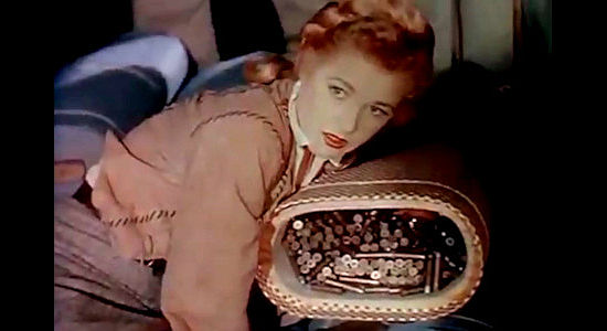 Audrey Long as Claire Conville, discovering concealed ammunition in a freight wagon in Cavalry Scout (1951)