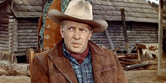 Bruce Bennett as 'Bull' Herrick, the cripple rancher who hires rival outlaw gangs to watch over his herd in Robbers' Roost (1955)