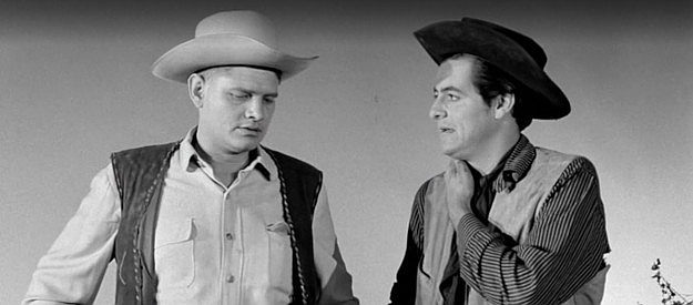 Charles Veltmann Jr. as Melvin Potter and Hank Delgado (aka Henry Darrow) as Wade Connor, discussing their changes in Revenge of the Virgins (1959)
