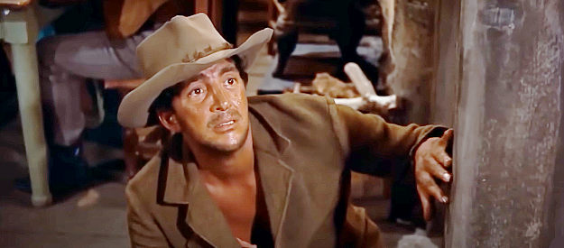 Dean Martin as Dude, tempted to reach into a spitoon to get money for a drink in Rio Bravo (1959)