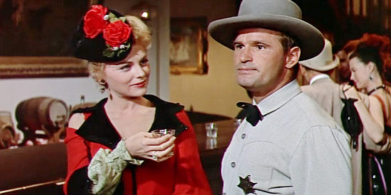 Joanne Crook as Brnady, offering a drink to Ben (Frank Chase), Judge Henry's assistant in Ride a Crooked Trail (1958)