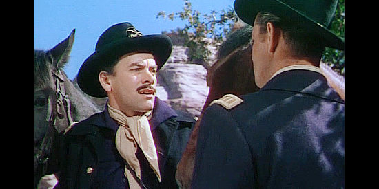 John Ireland as Gen. John Quantrell, explaining his Ute allies to Capt. Brett Sherwood in Red Mountain (1951)
