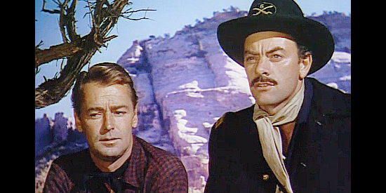 John Ireland (right) as Gen. John Quantrell, sharing his plans with Brett Sherwood (Alan Ladd) in Red Mountain (1951)