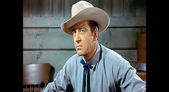 John Payne as Jefferson Harder, refusing to change course in his dealings with railroad workers reluctant to work in Rails Into Laramie (1954)