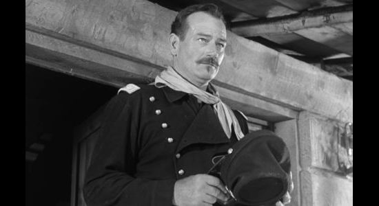 John Wayne as Lt. Col. Kirby York about to meet his new recruits in Rio Grande (1950)