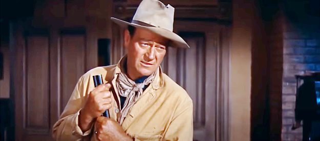 John Wayne as Sheriff John T. Chance, ready to protect his jail and his prisoner in Rio Bravo (1959)