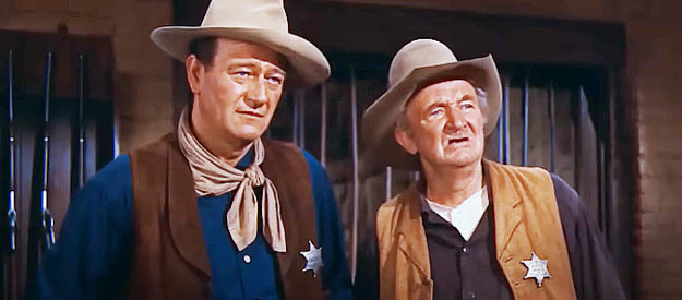John Wayne as Sheriff John T. Chance with his grumbling deputy Stumpy (Walter Brennan) in Rio Bravo (1959)