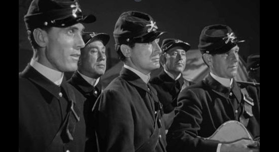 Ken Curtis (left) as Trooper Donnelly with the rest of the regimental singers in Rio Grande (1950)