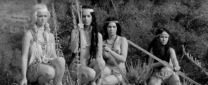 Nona Caver (right) as Yellow Gold with part of the Golden Horde, watching the gold-hunting party advance in Revenge of the Virgins (1959)