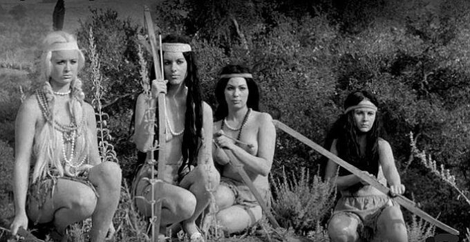 Nona Carver as Yellow Gold with part of the Golden Horde, watching the gold-hunting party advance in Revenge of the Virgins (1959)