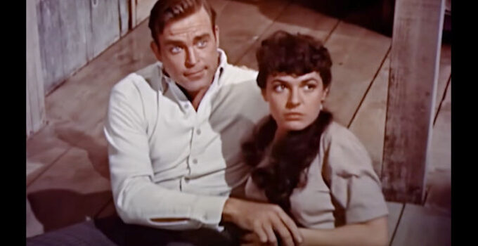 Scott Brady as Mitch Baker and Anne Bancroft as Angelita, caught in a comprising position in The Restless Breed (1957)