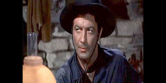 Robert Taylor as Rio, skeptical after King Cameron decides to spare his life in Ride, Vaquero! (1953)