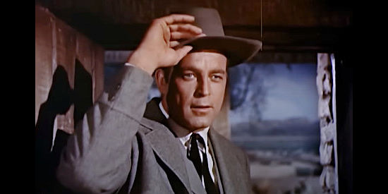Scott Brady as Mitch Baker, a man on a mission of vengeance, introducing himself to Rev. Simmons' family in The Restless Breed (1957)