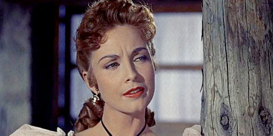 Sylvia Findley as Helen Herrick, trying to figure out why 'Tex' seems different than the other guns her brother has hired in Robbers' Roost (1955)