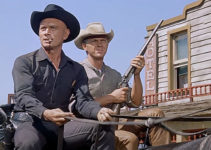 Yul Brynner as Chris Adams and Steve McQueen as Vin Tanner, working together to get a body to boot hill in The Magnificent Seven (1960)