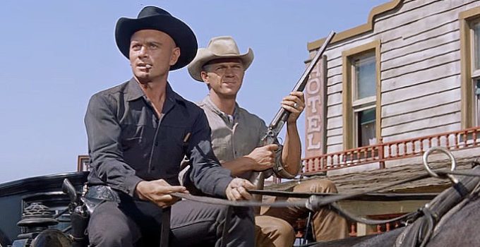 Yul Brynner as Chris Adams and Steve McQueen as Vin Tanner, working together to get a body to boot hill in The Magnificent Seven (1960)