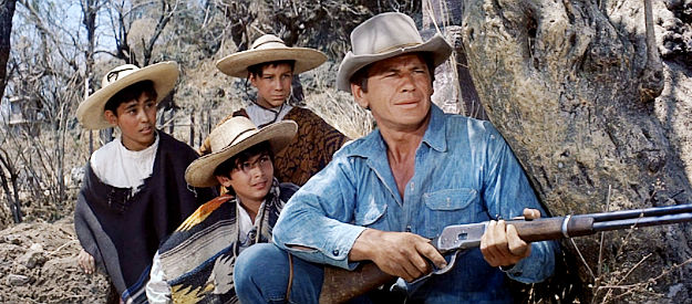 Charles Bronson as Bernardo O’Reilly with the three youths committed to tending his grave should he die in The Magnificent Seven (1960)