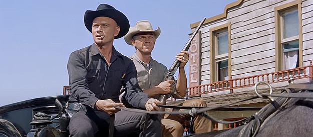 Yul Brynner as Chris Adams and Steve McQueen as Vin Tanner, working together to get a body to boot hill in The Magnificent Seven (1960)