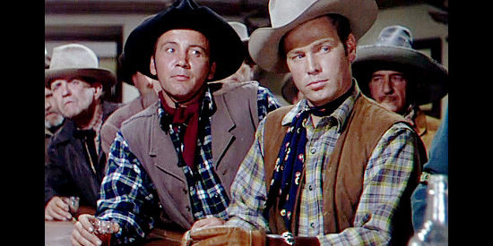 Cameron Mitchell as George Vird and Richard Crane as his brother Juke, two of Owen Merritt's ranch hands in Man in the Saddle (1951)