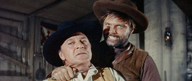 Jack Lord as Coaley, holding a knife to Link's throat to force Billie to undress in Man of the West (1958)