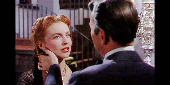 Joan Leslie as Laurie Birdwell, who marries Will Isham for money not love in Man in the Saddle (1951)
