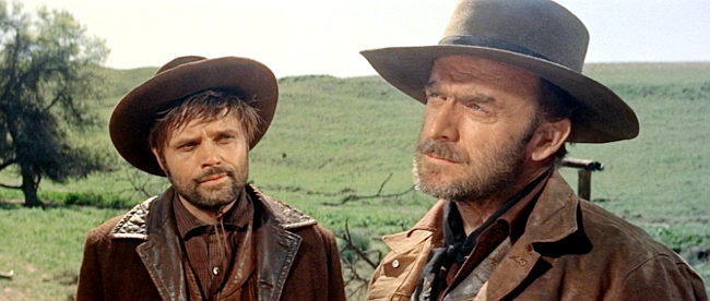 John Dehner as Claude (right), suspicious of Link as Coaley (Jack Lord) looks on in Man of the West (1958)