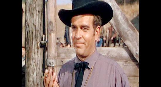 Douglas Kennedy as cattleman Rodney Ackroyd, timing Morgan Lane's ride on a bucking bronc in Montana (1950)