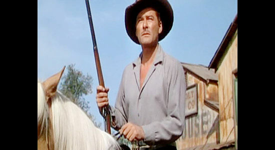 Errol Flynn as Morgan Lane, riding into town with his herd of sheep in Montana (1950)