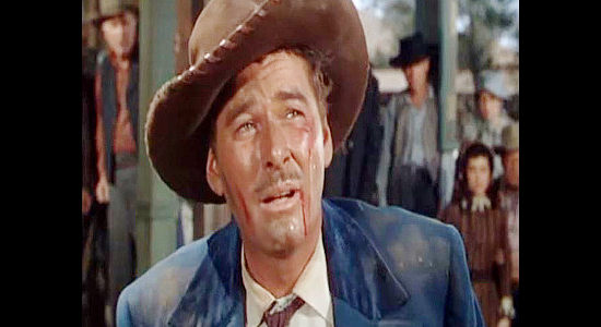 Errol Flynn as Morgan Lane, showing the signs of what happens when they find out you're a sheepherder in Montana (1950)