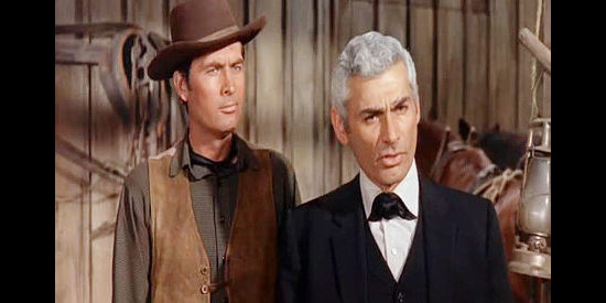 Fess Parker as Cam Bleeker and Jeff Chandler as Luke Darcy, planning a $500,000 heist in the town of Topeka in The Jayhawkers! (1959)