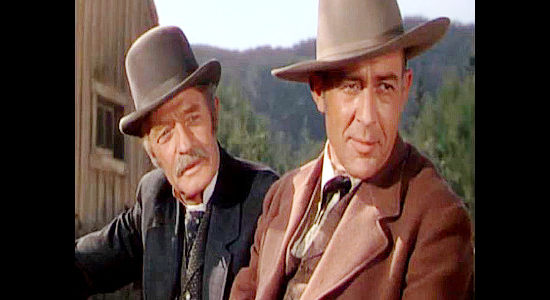 Forrest Taylor as banker Clark and Lester Matthews as cattle George Forsythe, ready to consider Lane's notion that cattle and sheep share the range in Montana (1950)