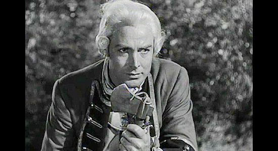 Glenn Langan as Capt. Jonathan West, the man who intends to protect, then marry Marion Thorne in The Iroquois Trail (1950)