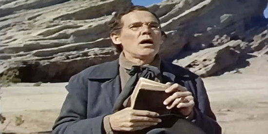 Henry Hull as Preacher Bentley, saying prayers over a fallen friend in Kentucky Rifle (1956)
