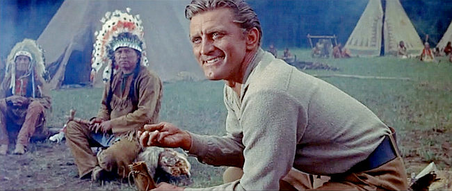 Kirk Douglas as Johnny Hawks, being shown some of the gold found on Indian land in The Indian Fighter (1955)