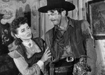 Catherine McLeod as Alice Sharp tries to help a wounded John Wesley Barker (John Carroll) in The Fabulous Texan (1947)