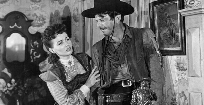 Catherine McLeod as Alice Sharp tries to help a wounded John Wesley Barker (John Carroll) in The Fabulous Texan (1947)