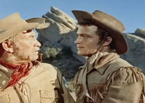 Chill Wills as Tobias Taylor and Lance Fuller as Jason Clay, debating the mix of women and guns in Kentucky Rifle (1956)