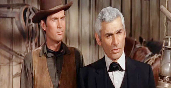 Fess Parker as Cam Bleeker and Jeff Chandler as Luke Darcy, planning a $500,000 heist in the town of Topeka in The Jayhawkers! (1959)