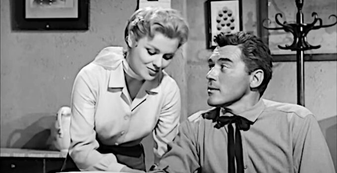 Kathleen Crowley as Fran Maroon, dealing with flirting by Glen Hayden (William Bishop) while mending his arm in The Phantom Stagecoach (1957)