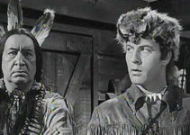 Monte Blue as Sagamore and George Montgomery as Nat Cutler, wondering how to prove Ogane is the real traitor in The Iroquois Trail (1950)