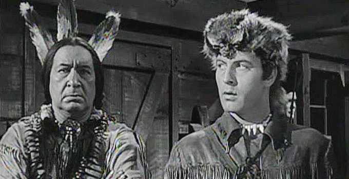 Monte Blue as Sagamore and George Montgomery as Nat Cutler, wondering how to prove Ogane is the real traitor in The Iroquois Trail (1950)